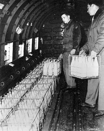 Bottles of milk are loaded into an aircraft for a shipment of goods over Berlin during the Berlin Airlift.